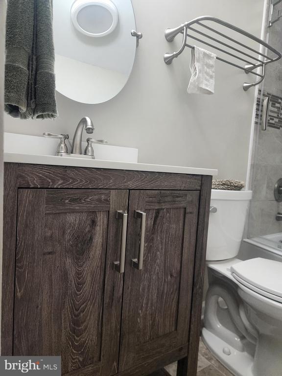 full bath featuring tub / shower combination, toilet, and vanity