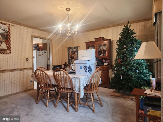 dining room featuring wallpapered walls, an inviting chandelier, crown molding, and light carpet