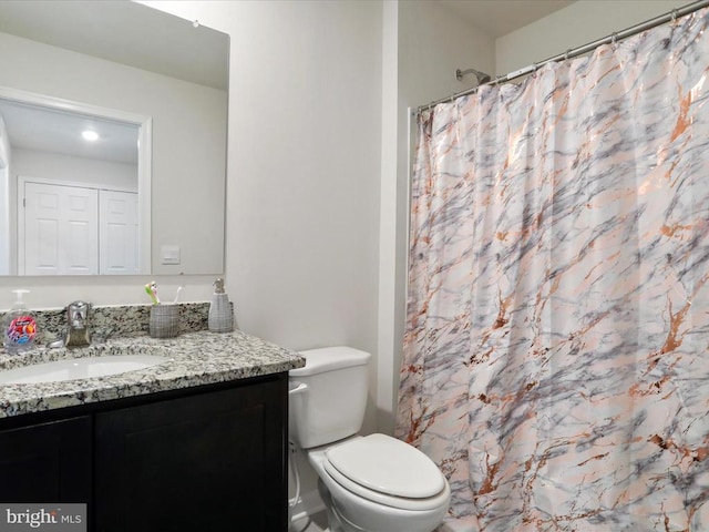 bathroom featuring vanity, a shower with shower curtain, and toilet