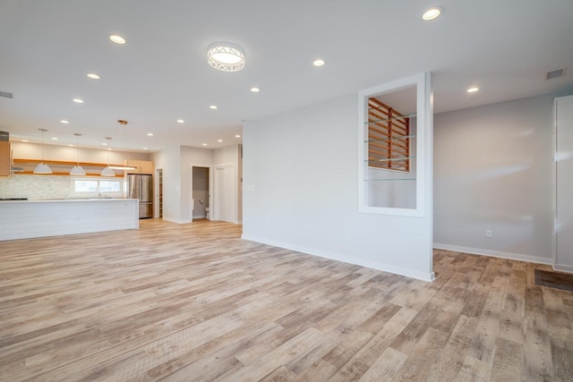 unfurnished living room featuring light hardwood / wood-style floors