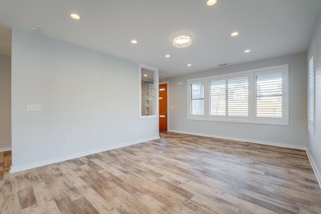 spare room with light hardwood / wood-style floors