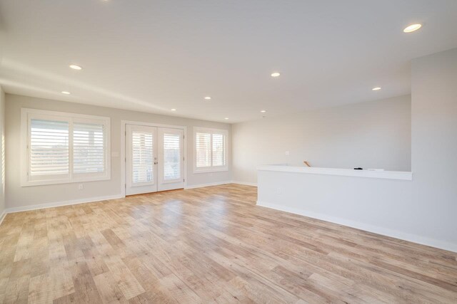 unfurnished room with light hardwood / wood-style floors and french doors