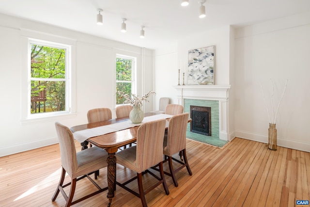 dining area with baseboards, a wealth of natural light, and light wood finished floors