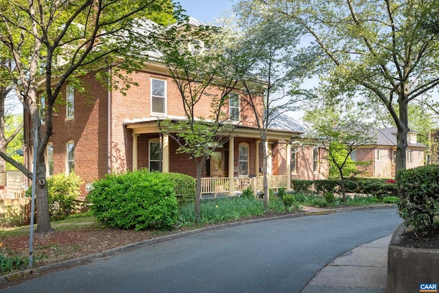view of front of property with brick siding and a porch