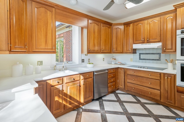 kitchen with light countertops, dishwasher, under cabinet range hood, and black electric cooktop