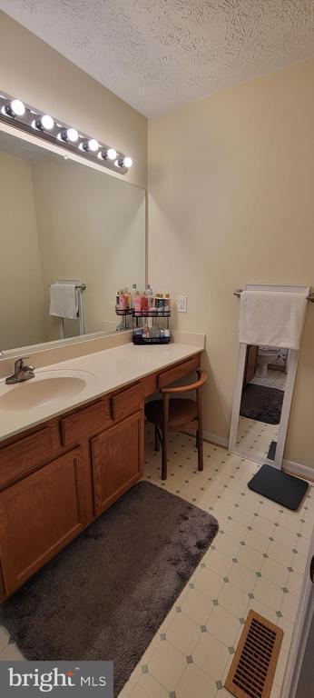 bathroom with vanity and a textured ceiling