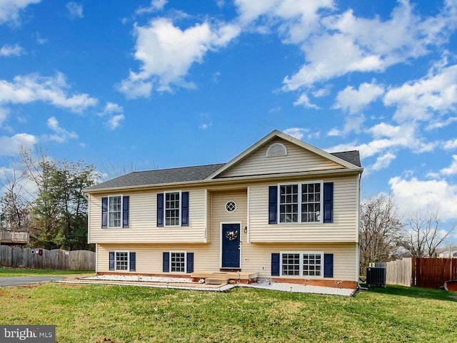 split foyer home with central AC, a front yard, and a patio area