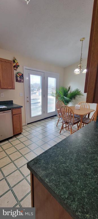 tiled dining area featuring a chandelier