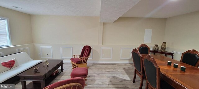 interior space featuring light hardwood / wood-style floors and a textured ceiling