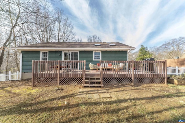 back of property featuring a wooden deck and fence