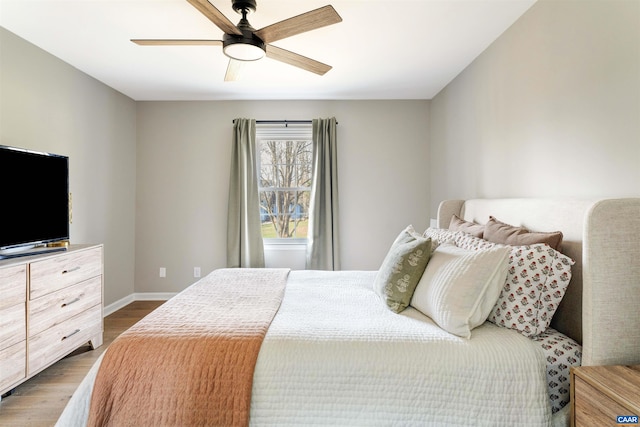 bedroom featuring a ceiling fan, baseboards, and dark wood-style flooring