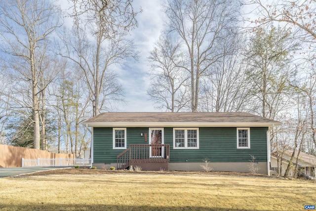 view of front of home featuring crawl space, a front lawn, and fence