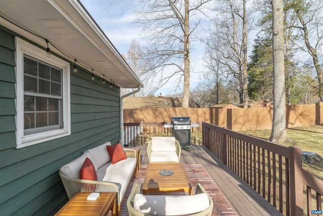 deck with an outdoor living space, area for grilling, and fence