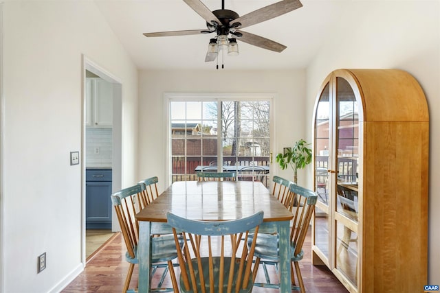 dining area with dark wood finished floors and ceiling fan