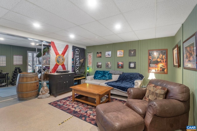 living room featuring a drop ceiling