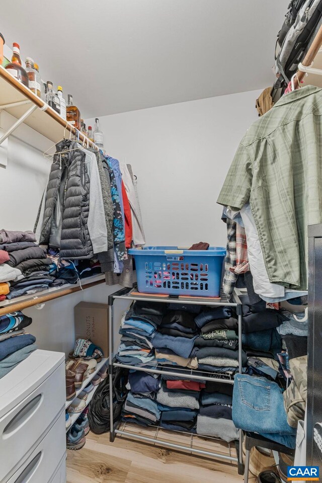 spacious closet featuring light hardwood / wood-style flooring