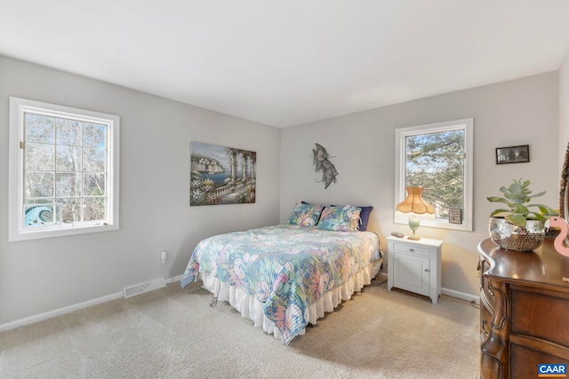 bedroom with light colored carpet