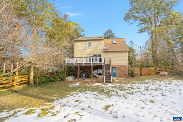 snow covered property with a wooden deck