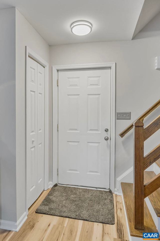 doorway with hardwood / wood-style flooring