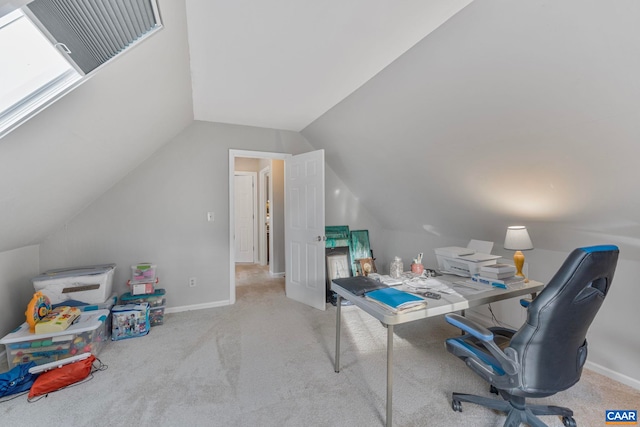 carpeted office space featuring vaulted ceiling