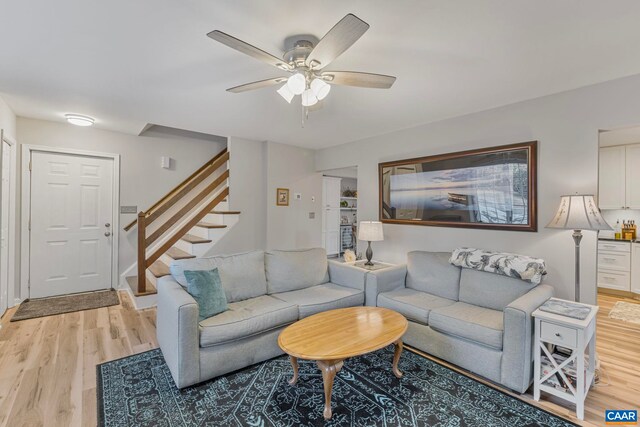 living room featuring ceiling fan and light wood-type flooring