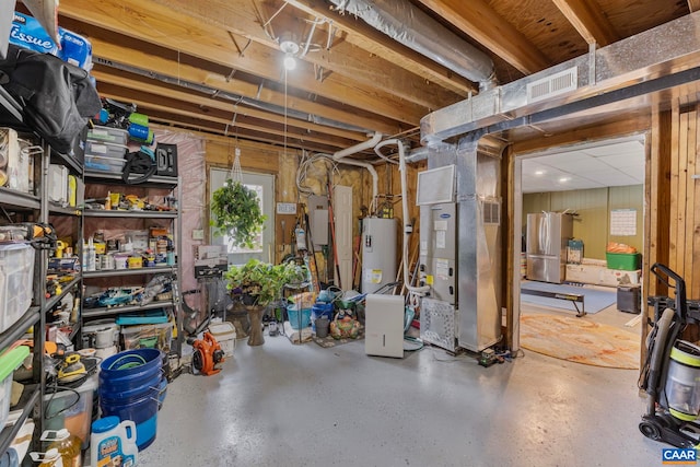 basement featuring heating unit, stainless steel fridge, electric panel, and water heater