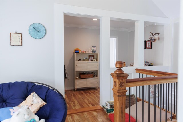 interior space with ornamental molding and wood-type flooring