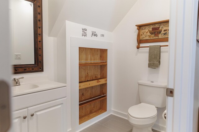 bathroom featuring vanity, tile patterned flooring, and toilet