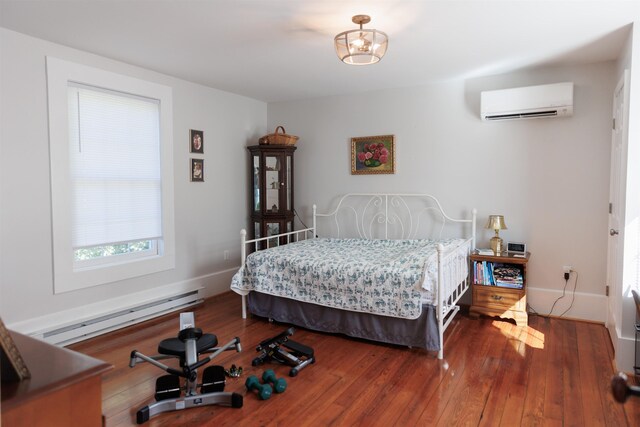 bedroom featuring a wall mounted air conditioner, wood-type flooring, and a baseboard heating unit