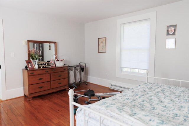 bedroom featuring dark wood-type flooring and a baseboard radiator