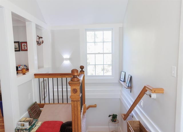 stairs with vaulted ceiling