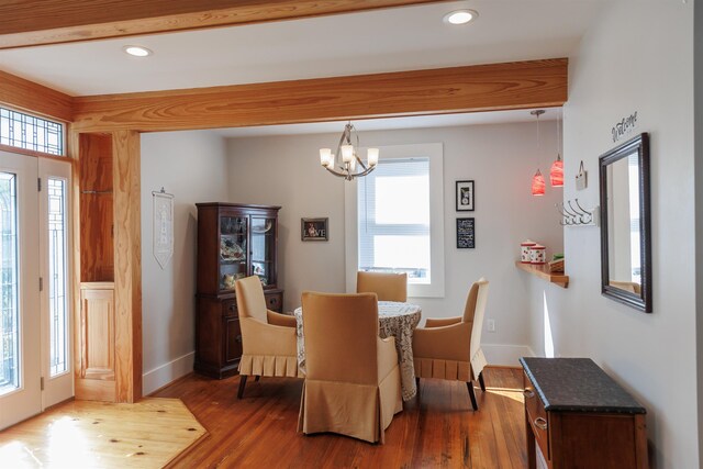 dining area featuring an inviting chandelier and dark wood-type flooring