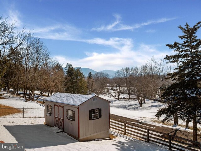 snow covered structure featuring a mountain view