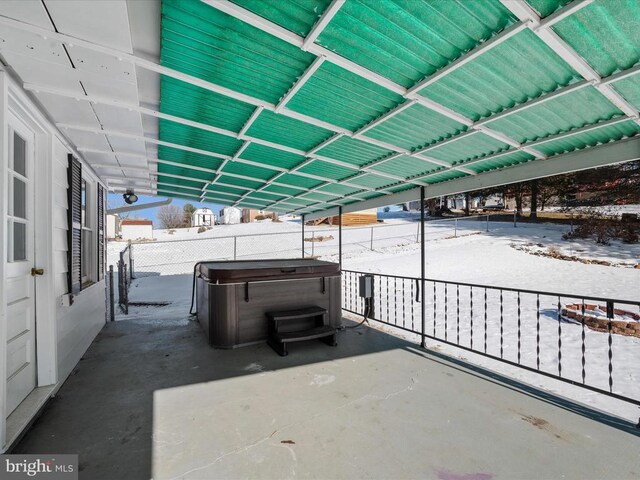 snow covered patio with a hot tub