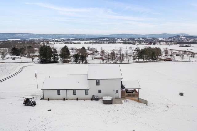 snowy aerial view with a mountain view