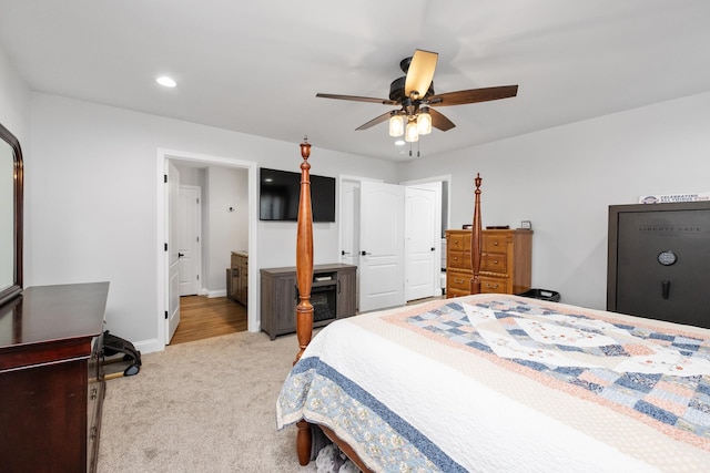 bedroom featuring light colored carpet and ceiling fan