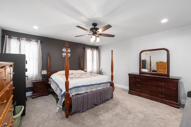 bedroom with light carpet, multiple windows, and ceiling fan