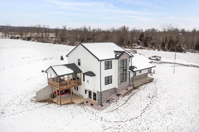 snow covered property featuring a deck