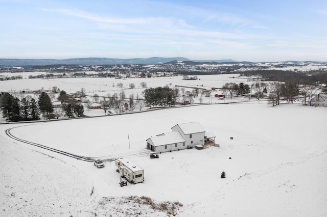 snowy aerial view featuring a mountain view