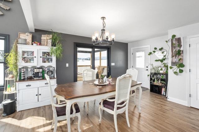 dining area featuring a chandelier and light hardwood / wood-style flooring