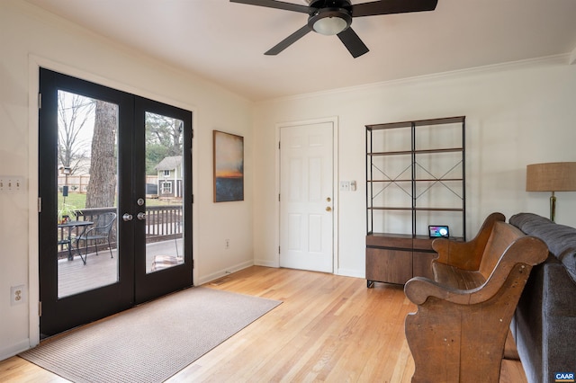 interior space featuring crown molding, baseboards, wood finished floors, and french doors