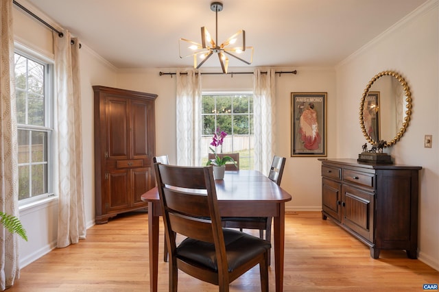 dining area featuring ornamental molding, a wealth of natural light, and light wood finished floors