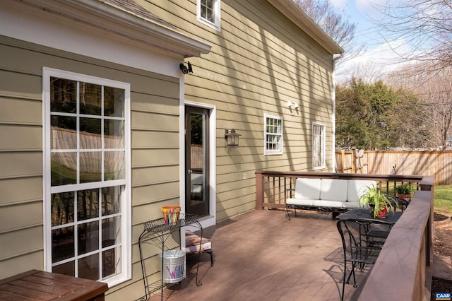 deck with an outdoor hangout area and fence