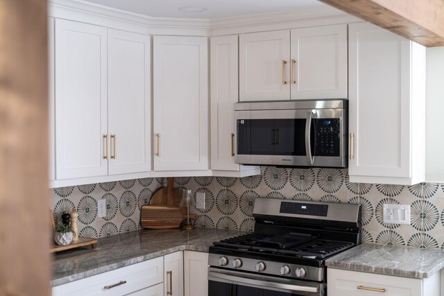 kitchen with white cabinetry, tasteful backsplash, and appliances with stainless steel finishes