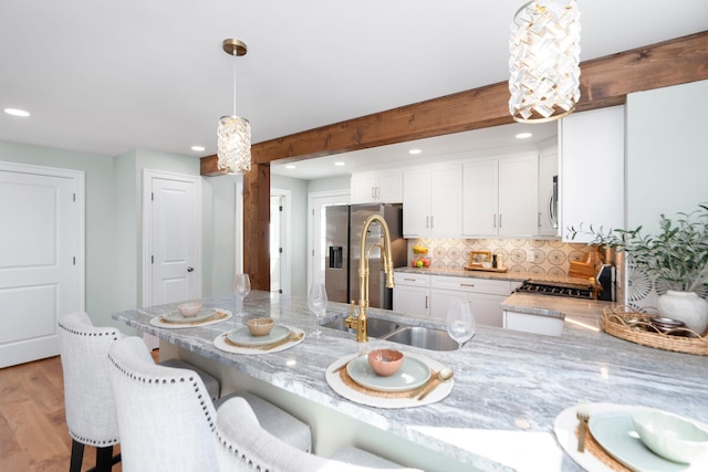 dining space featuring beamed ceiling, recessed lighting, and light wood-style floors