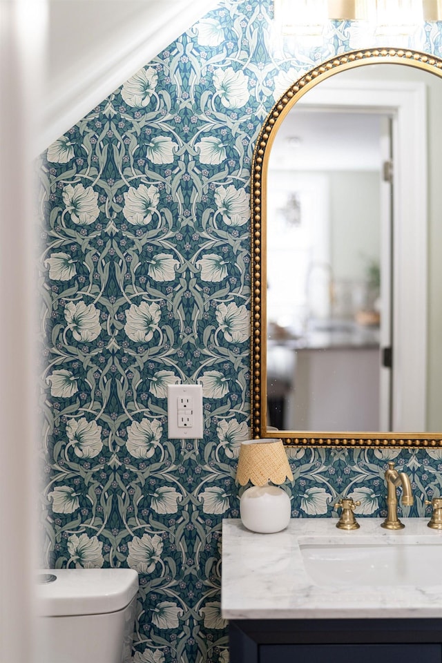 bathroom featuring toilet and vanity