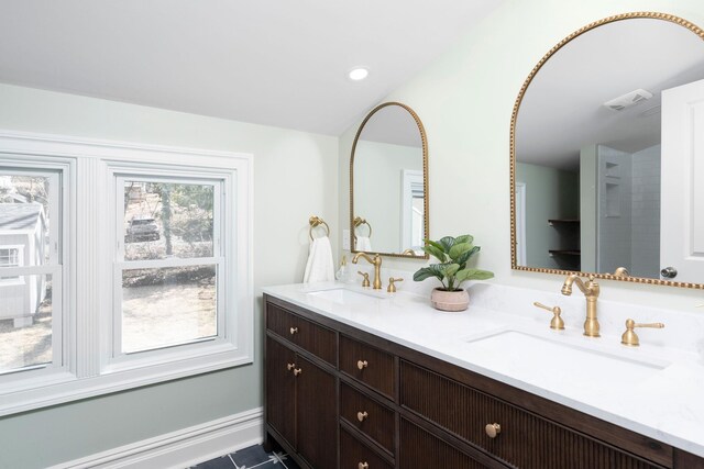 bathroom featuring a sink, visible vents, recessed lighting, and double vanity