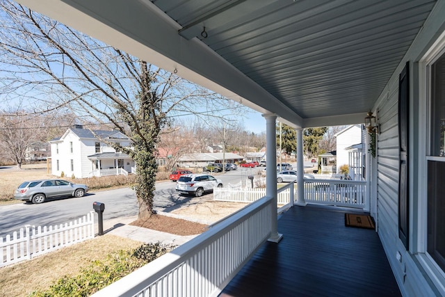 balcony with covered porch and a residential view