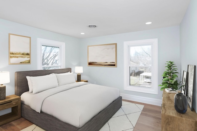 bedroom featuring recessed lighting, visible vents, light wood finished floors, and baseboards