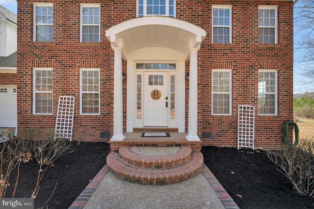 doorway to property featuring brick siding